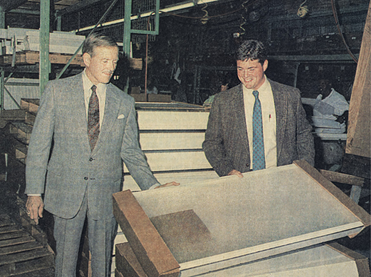 John Williams and Mark Williams looking at finished fixtures on the factory floor in the 90s